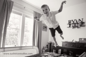 Boy leaping onto bed
